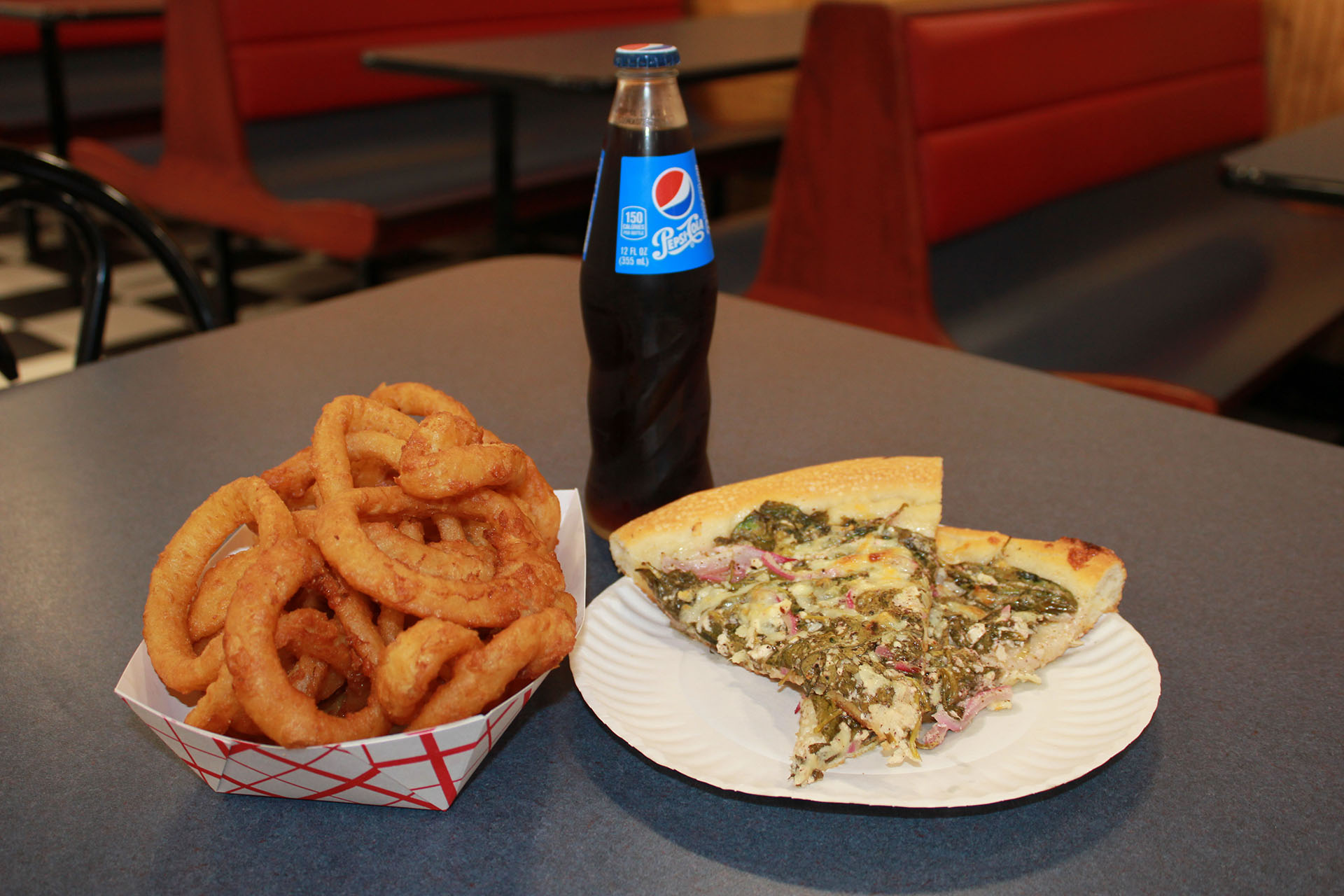 Have a drink, onion rings, and pizza.